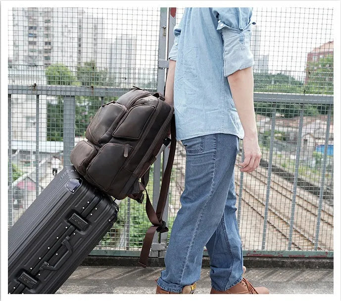 Dark brown retro crazy horse leather men's backpack showing external pockets and internal organiser for a 17-inch laptop.