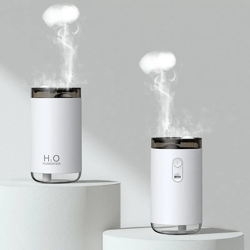 Blue jellyfish USB humidifier with night light on wooden table, showing mist output