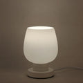 Nordic touch glass desk lamp with three colour modes and USB power on a bedside table