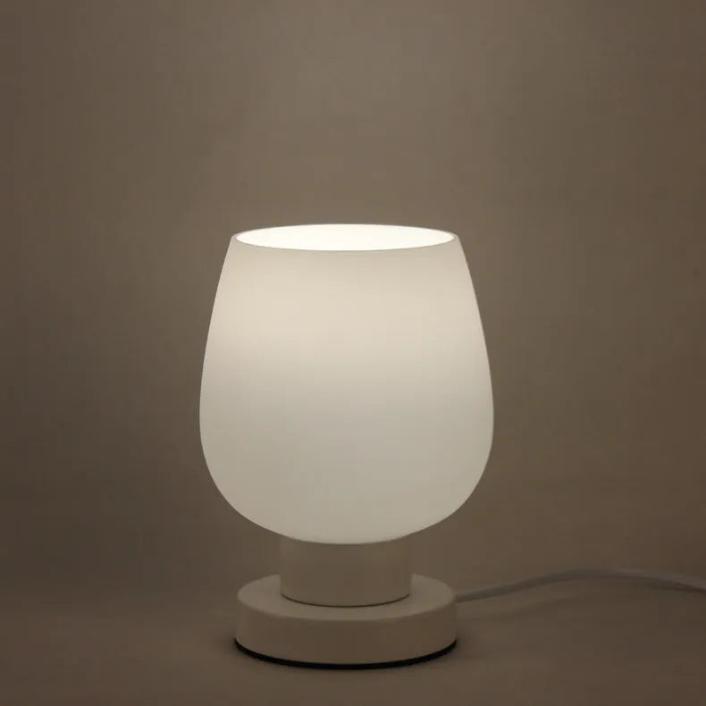 Nordic touch glass desk lamp with three colour modes and USB power on a bedside table