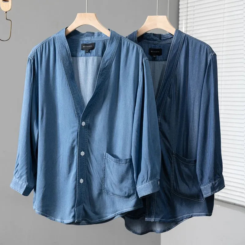Men's dark blue three-quarter sleeve V-neck casual denim coat laid flat.