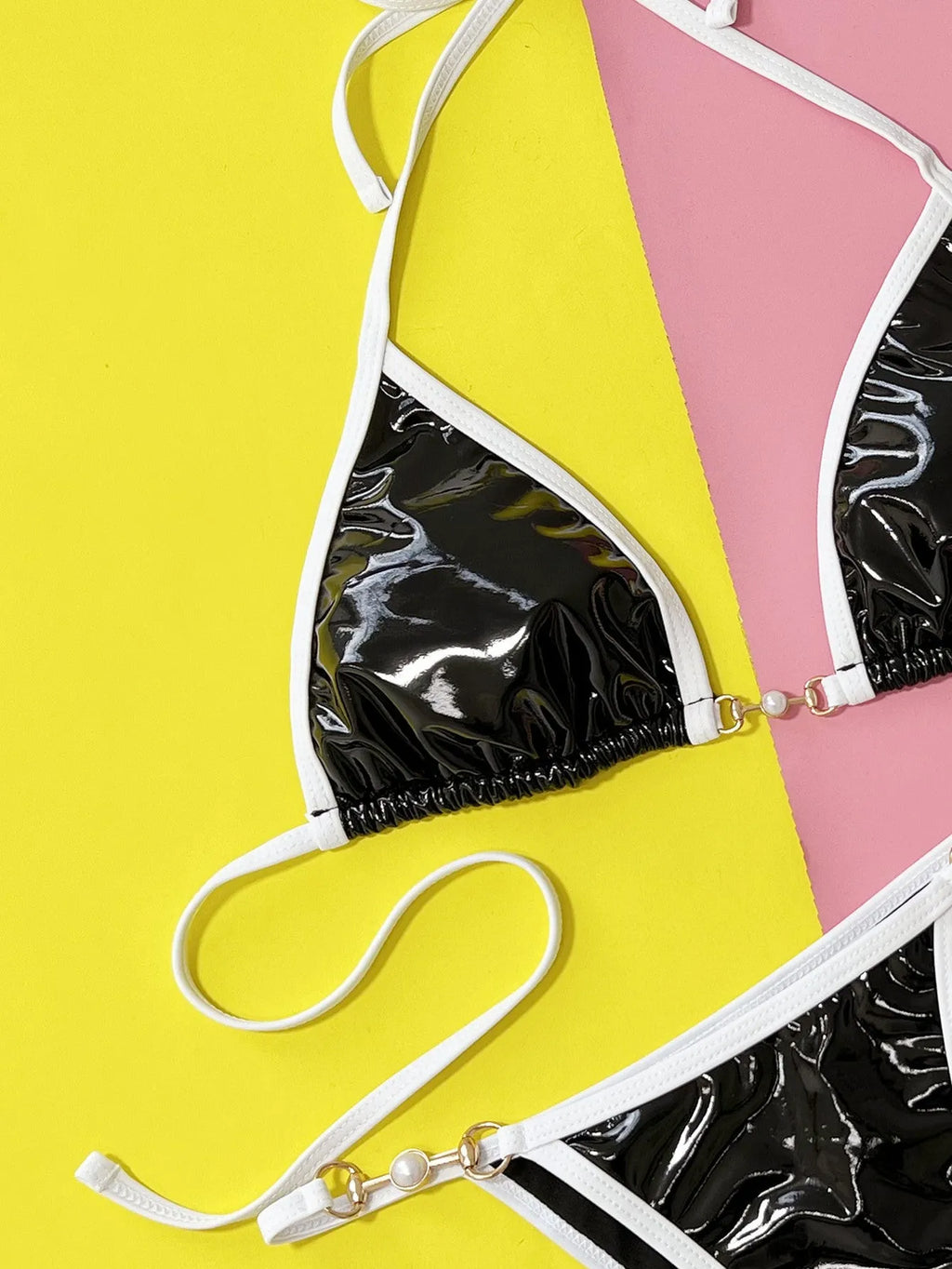 Black women's bikini swimsuit with triangle cup top and briefs on white background