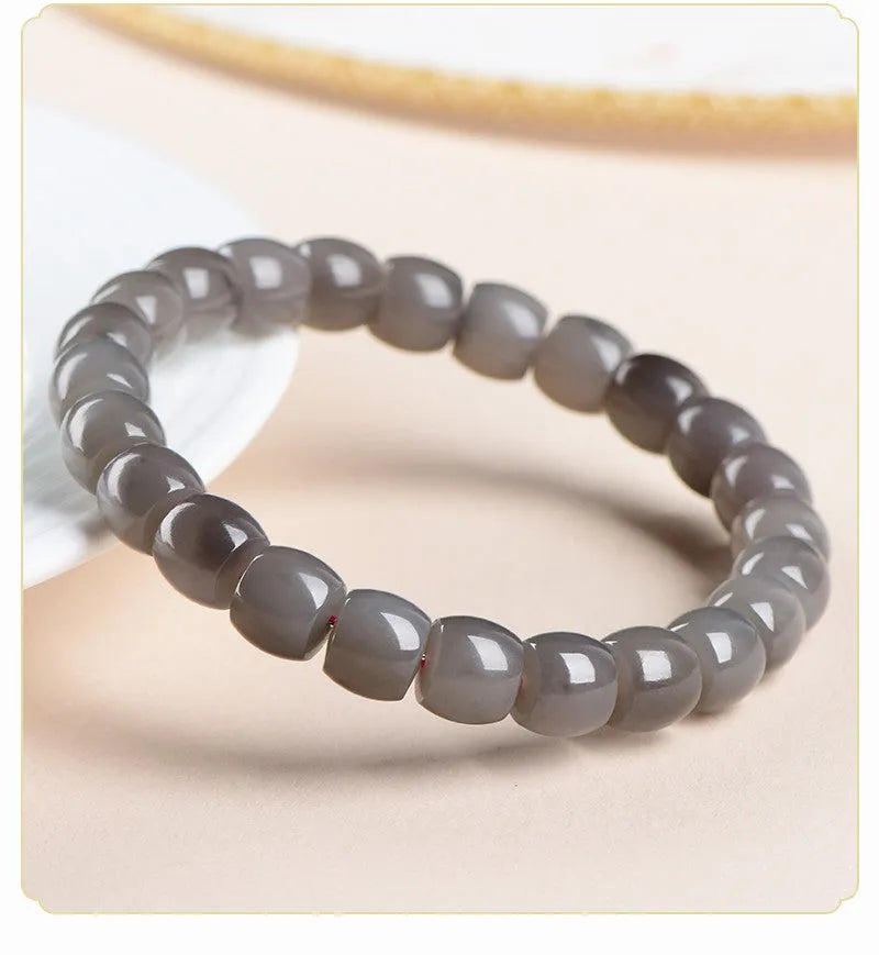 Natural smokey violet Hetian jade straight cut bead bracelet on wrist.