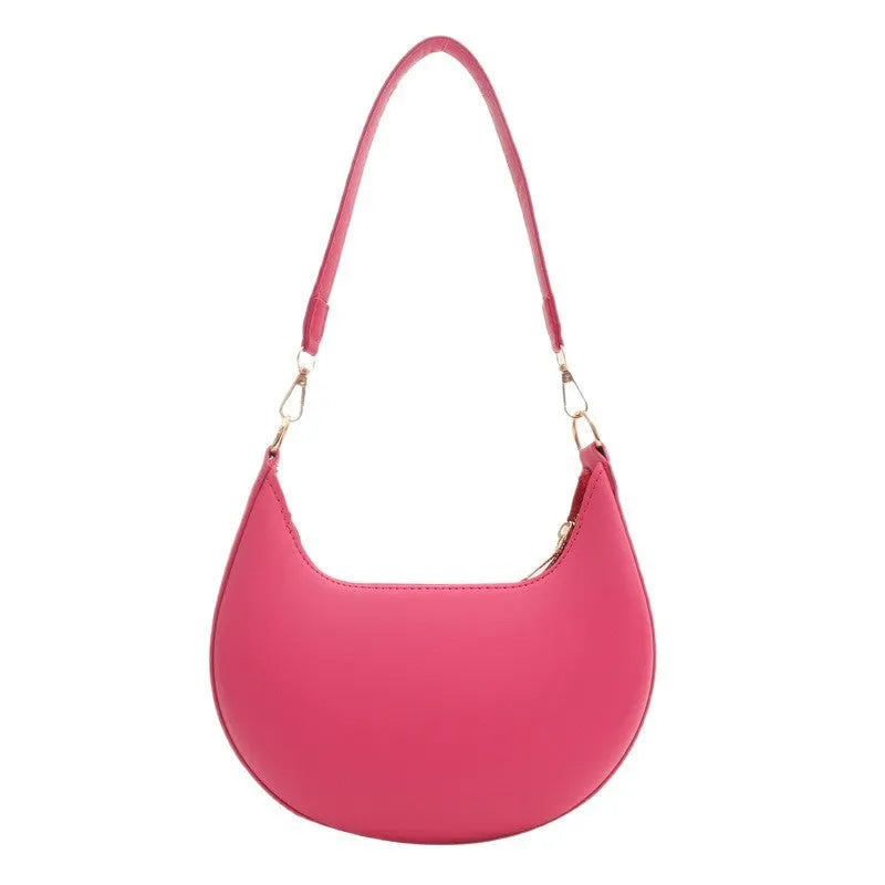 Round black women's one-shoulder underarm bag with sewing line details and a single strap.