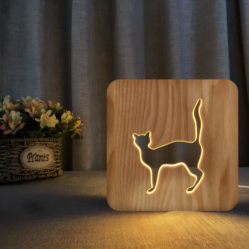 Solid wood 3D cat silhouette night light with hollow design and USB power cord.