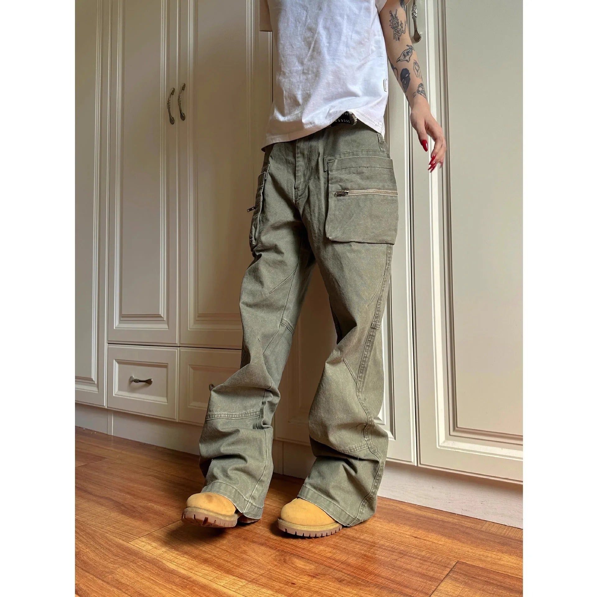 Green and black double zipper casual cotton pants with an elasticated waistband on a hanger.