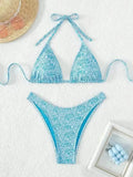 Women's flower pattern halter bikini top and shorts set in emerald green.