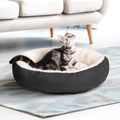 Circular grey cloth pet bed with raised sides for a cat or small dog