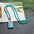 Turquoise necklace with a hand-woven stone mesh flower lucky pendant on a ball bead chain.