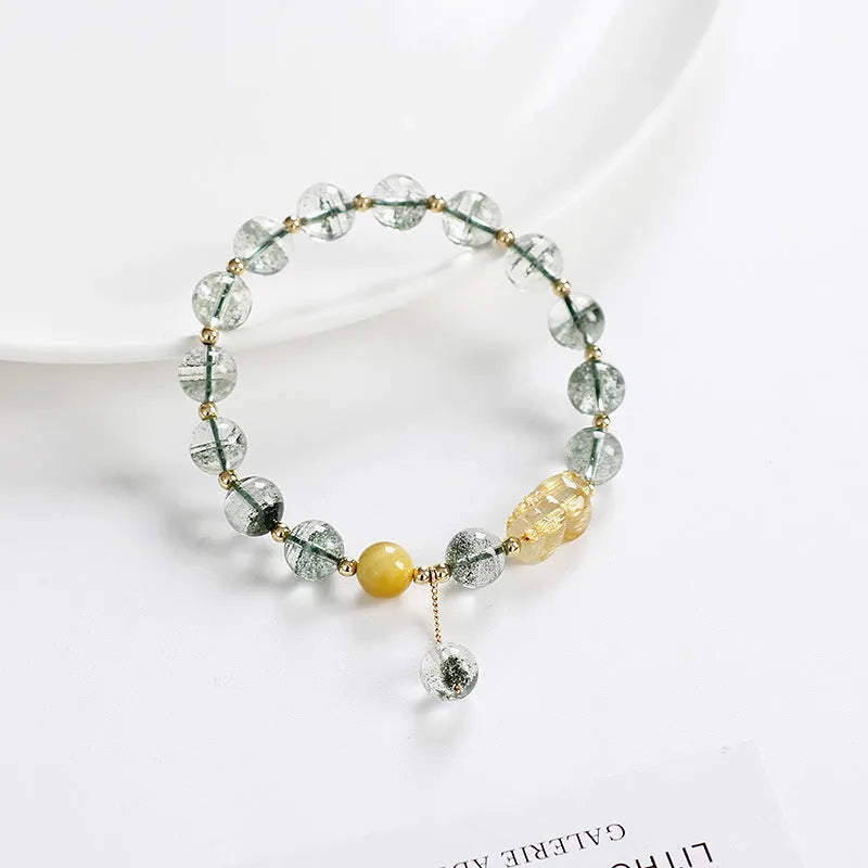 Green phantom quartz crystal bracelet with geometric design and gold rutile accents