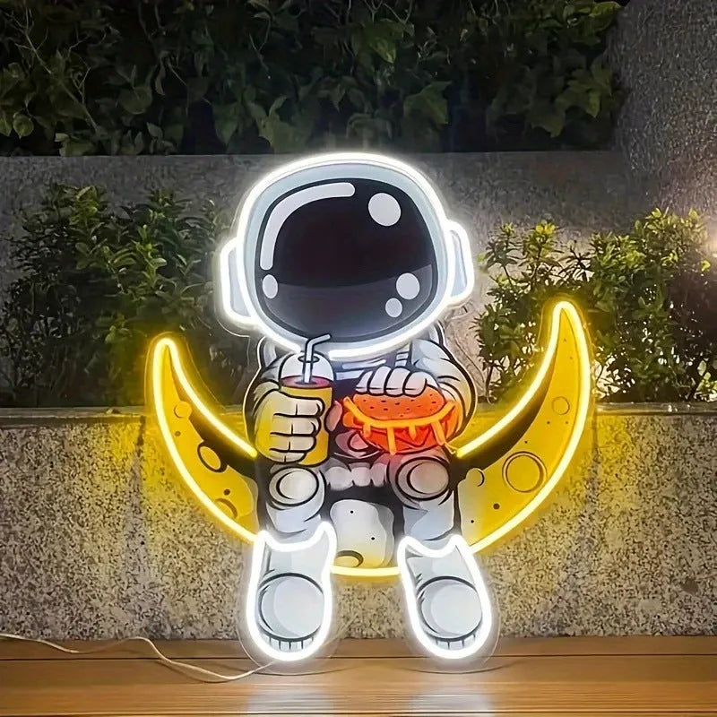 Blue and yellow astronaut-shaped neon light sign mounted on a wall