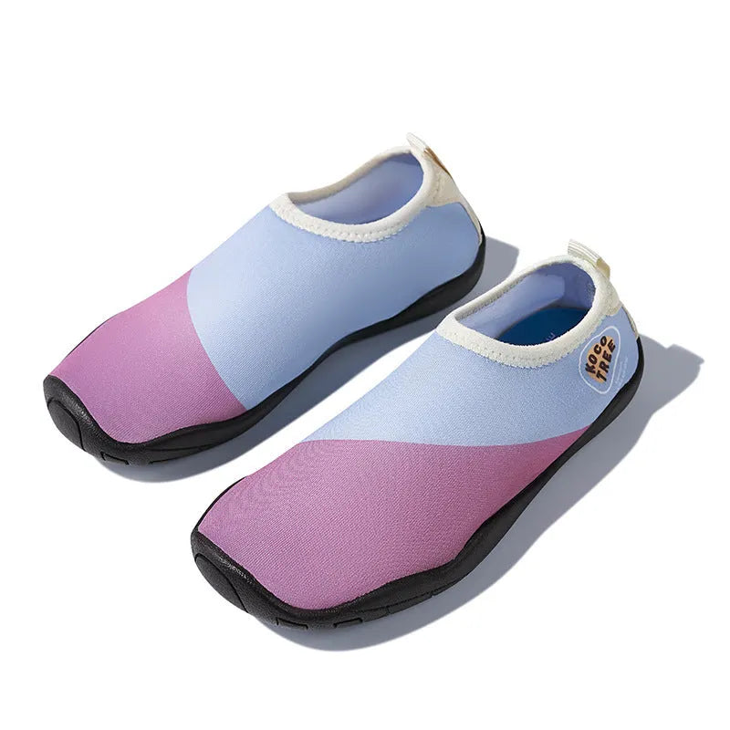 Children's beach shoes in bright colours with anti-slip rubber sole and textured upper.