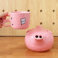 Creative ceramic piggy teapot nose mug set with pink pig pot and rabbit cup on a table