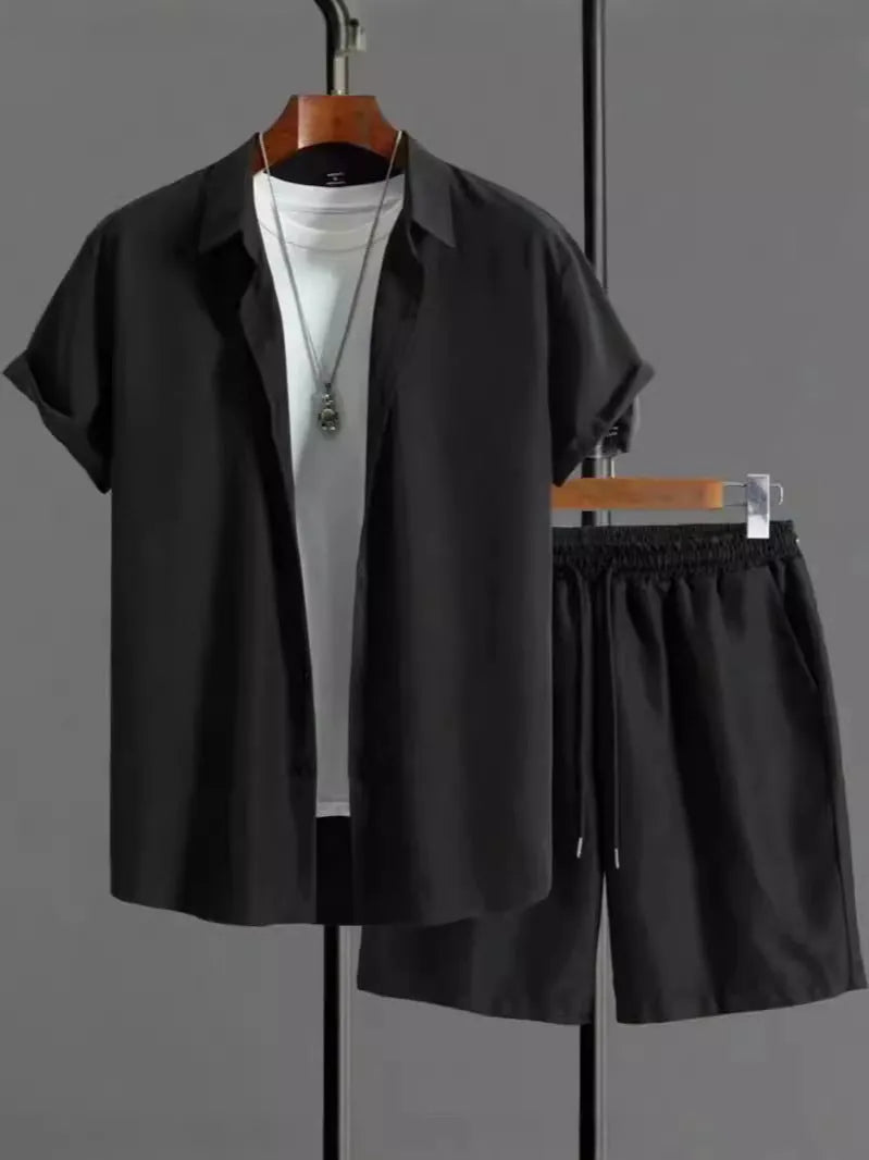 Man wearing a black and white jacquard patterned short sleeve suit shirt with matching formal shorts.