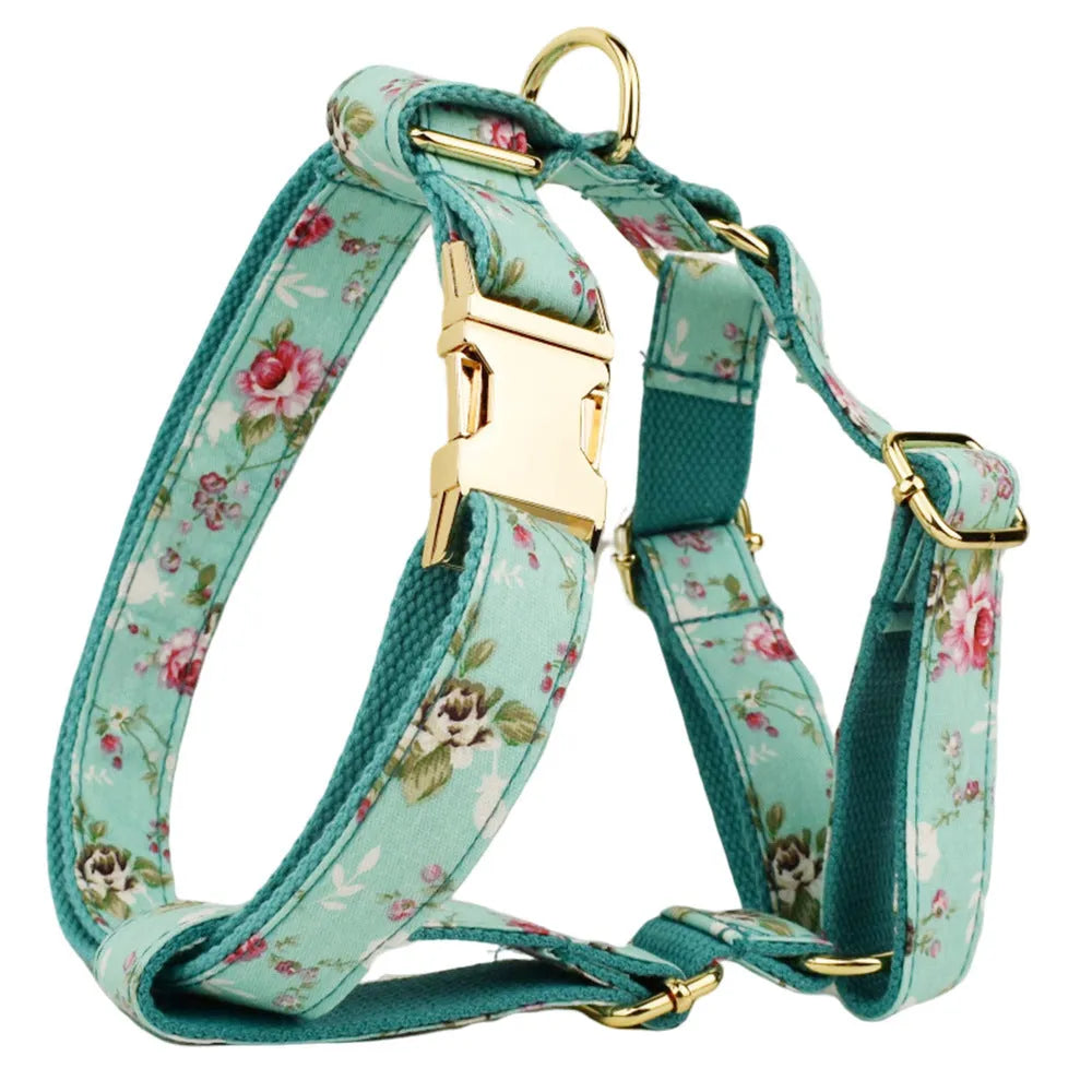 Rose-coloured fabric dog collar set with green background, includes leash, detachable bow, and vest for dogs.