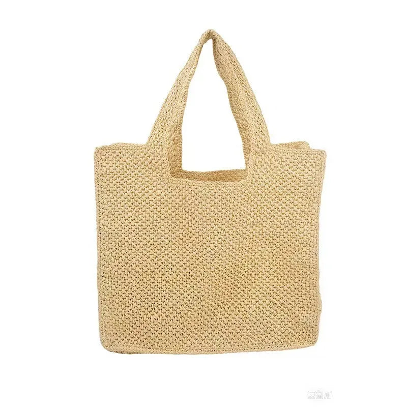 Woven straw bucket tote bag in a neutral colour with double straps and an open outer pocket.