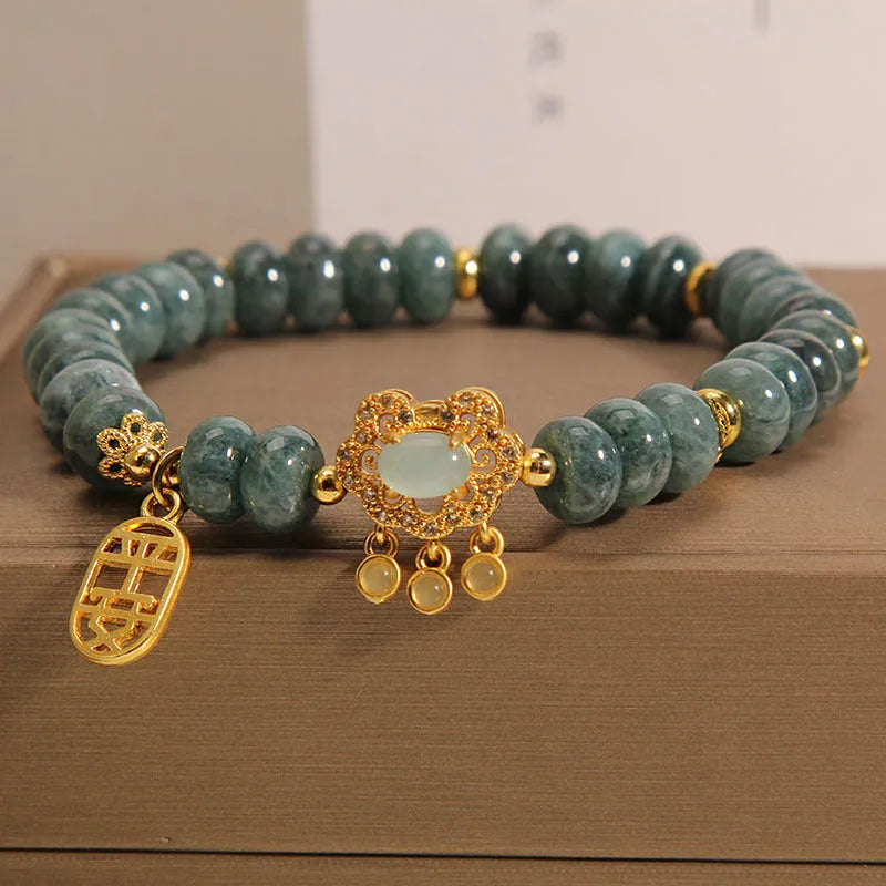 Women's bracelet with green jade abacus beads and a metallic safety lock clasp.