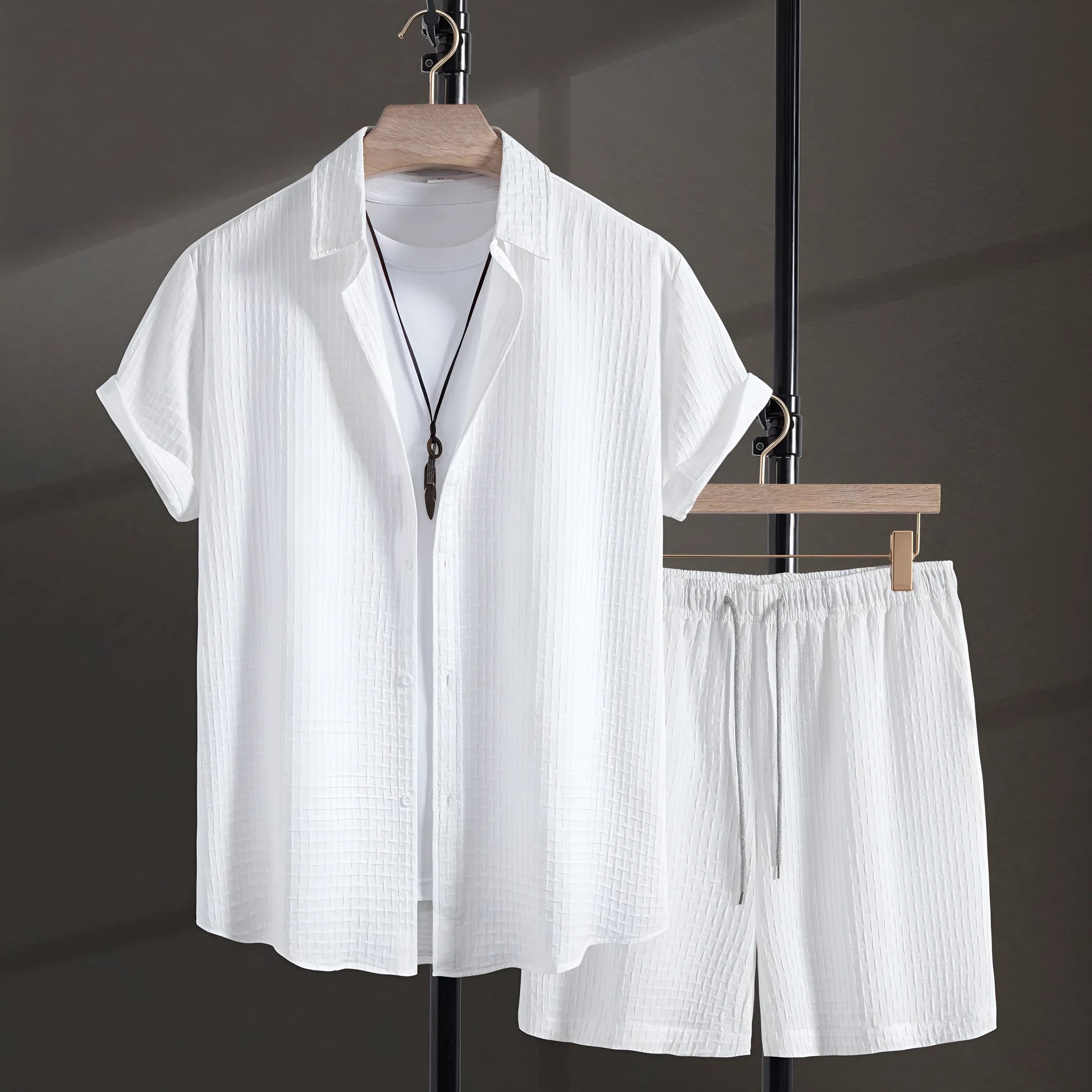Men's loose fit cotton blend beach shorts suit in black, showing short sleeve shirt and matching shorts.