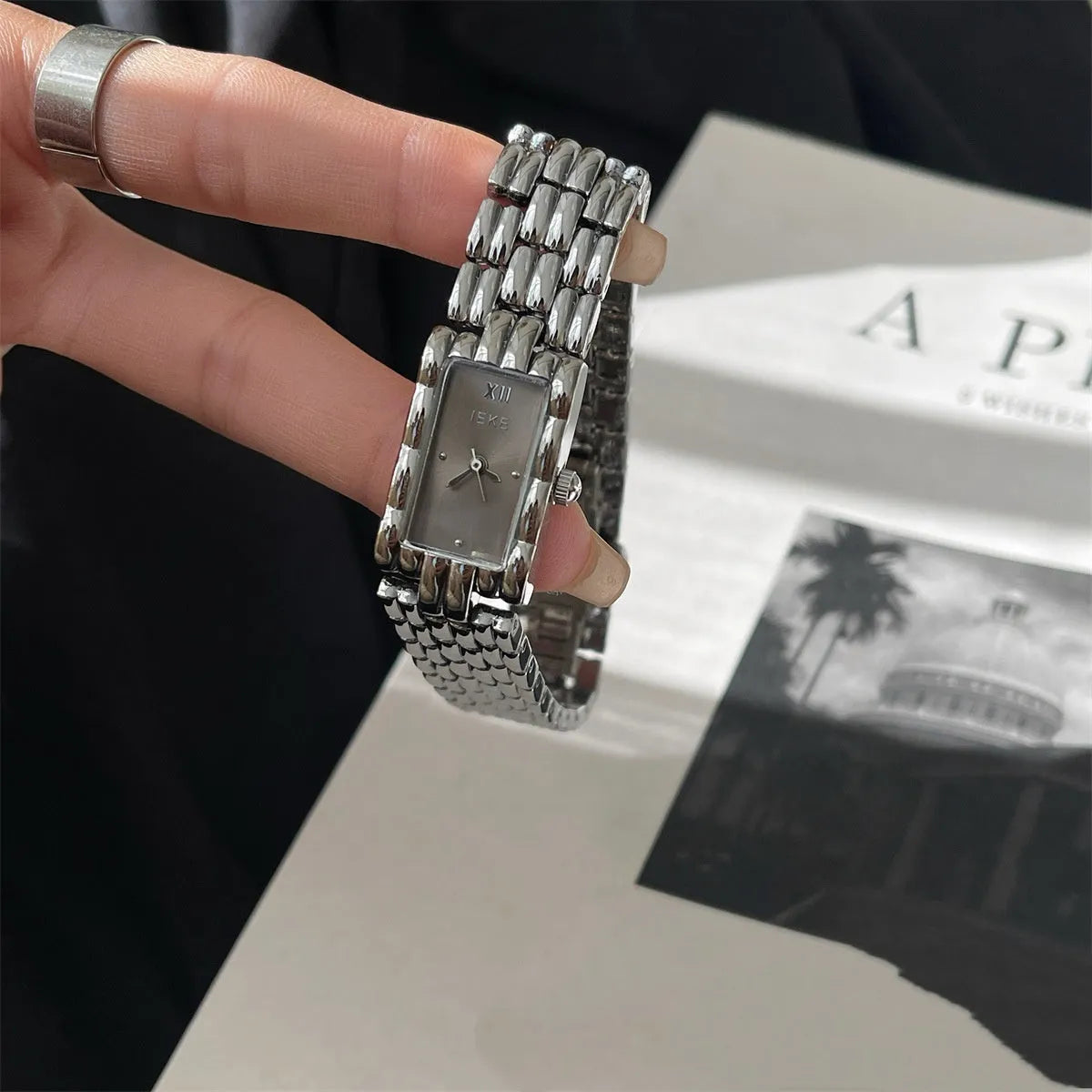 Women's silver and gold bracelet-style watch with a small 15mm dial and butterfly clasp.