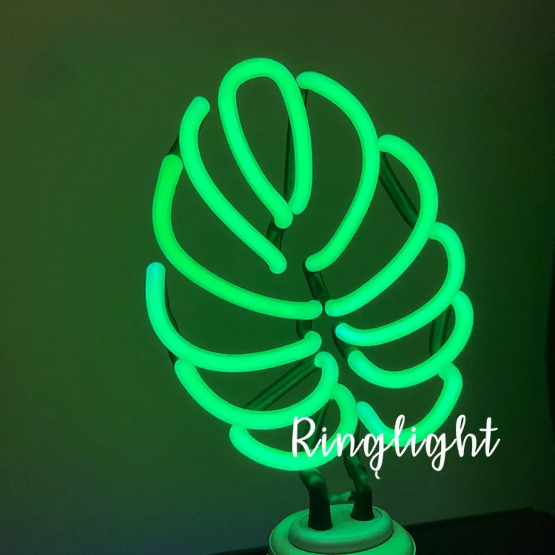 Minimalist white bamboo-shaped desktop lamp with a green glow, shown in two size options.