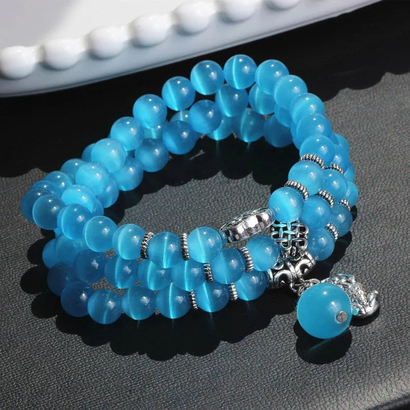 Opal crystal bracelet with geometric cat eye design showing three wraps around wrist