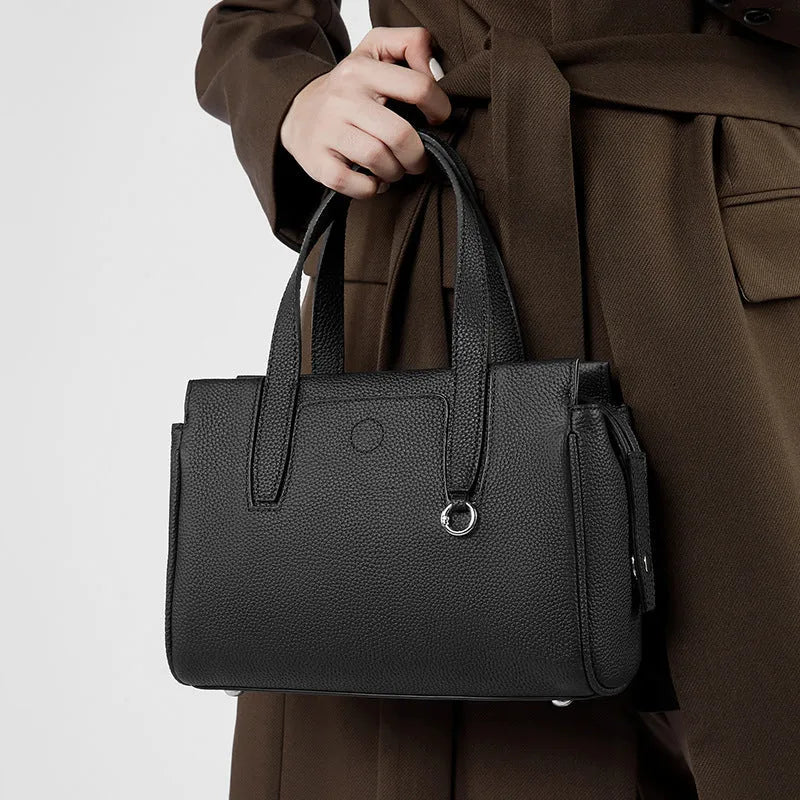 Genuine leather crossbody bag in horizontal square design with single strap, shown in black colour option.