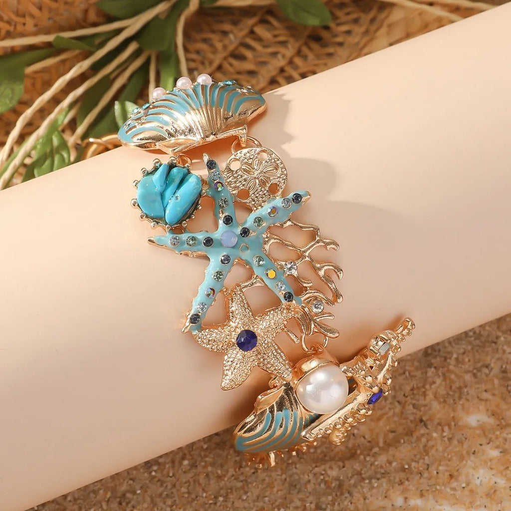 Women's alloy marine-themed bracelet with anchor, shell, and starfish charms in blue, red, or turquoise.