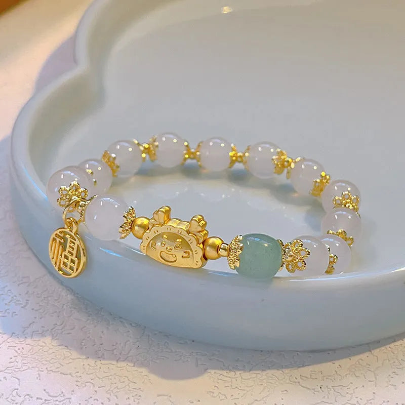Women's floral glazed bracelet with zodiac animal charm in red, pink or white bead colours