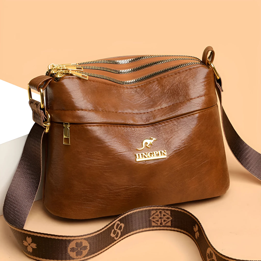 Cross body messenger bag in horizontal square shape with multiple compartments and sandwich pocket construction