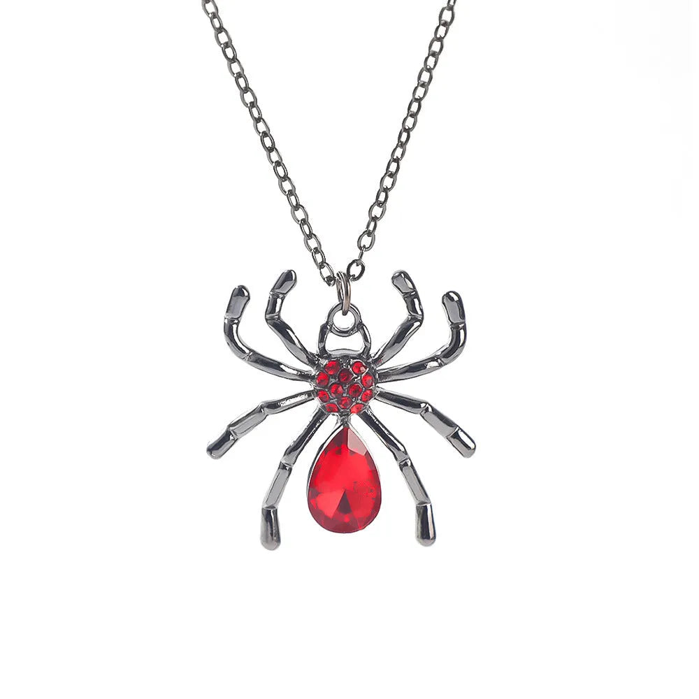 Halloween necklace with spider, bat, cross, and heart charm pendants on a metal chain.
