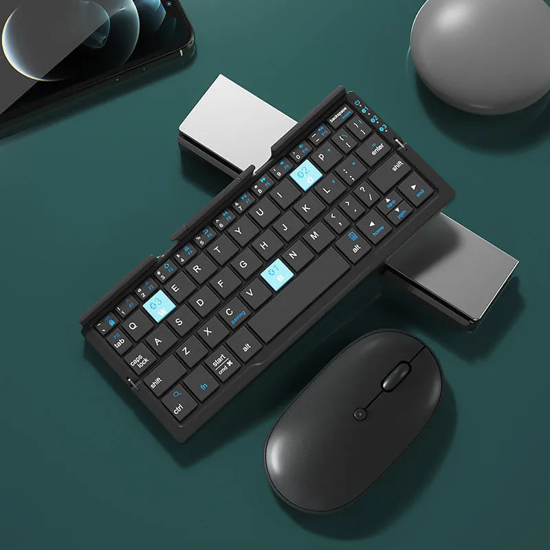 Silver white folding Bluetooth keyboard open with phone in stand next to closed black grey version