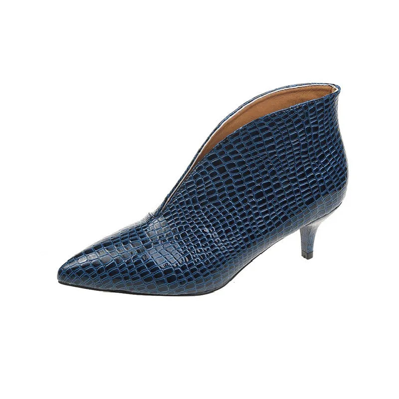 Women's black V-cut pointed toe Martin boots with embossed detail and a chunky heel.
