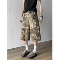 Yellow denim jeans with snake camouflage print and cropped leg length.