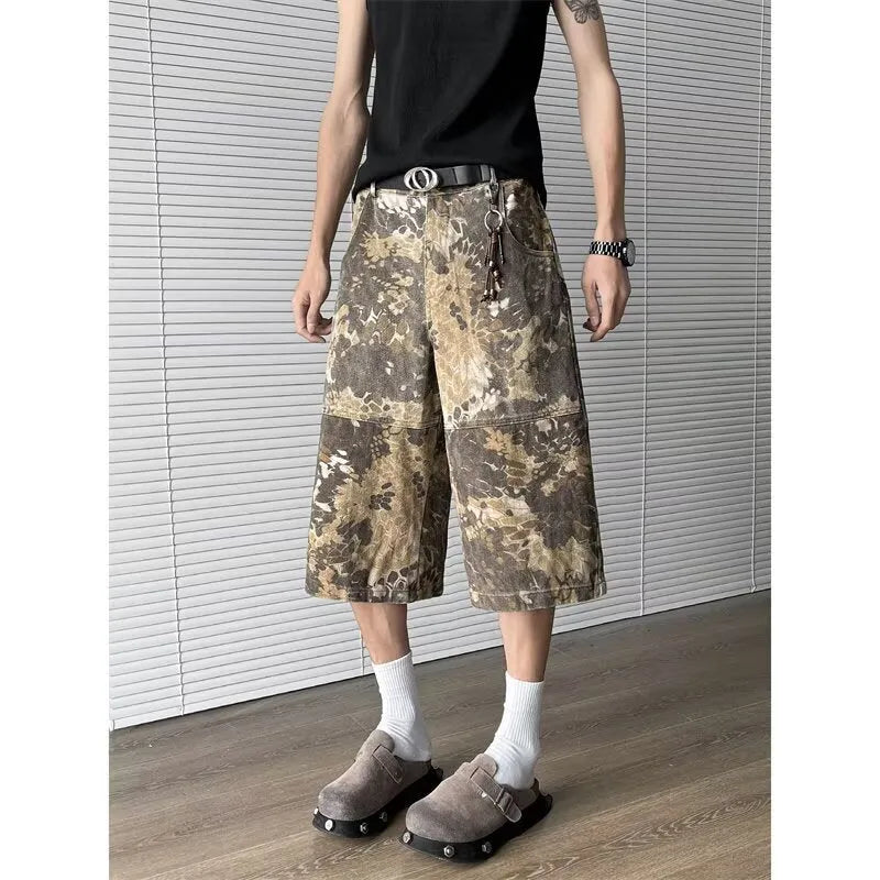 Yellow denim jeans with snake camouflage print and cropped leg length.