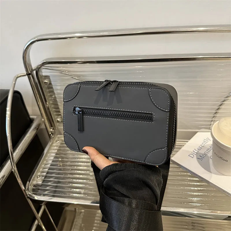 Women's black PU leather square crossbody bag with adjustable strap and outer pocket.