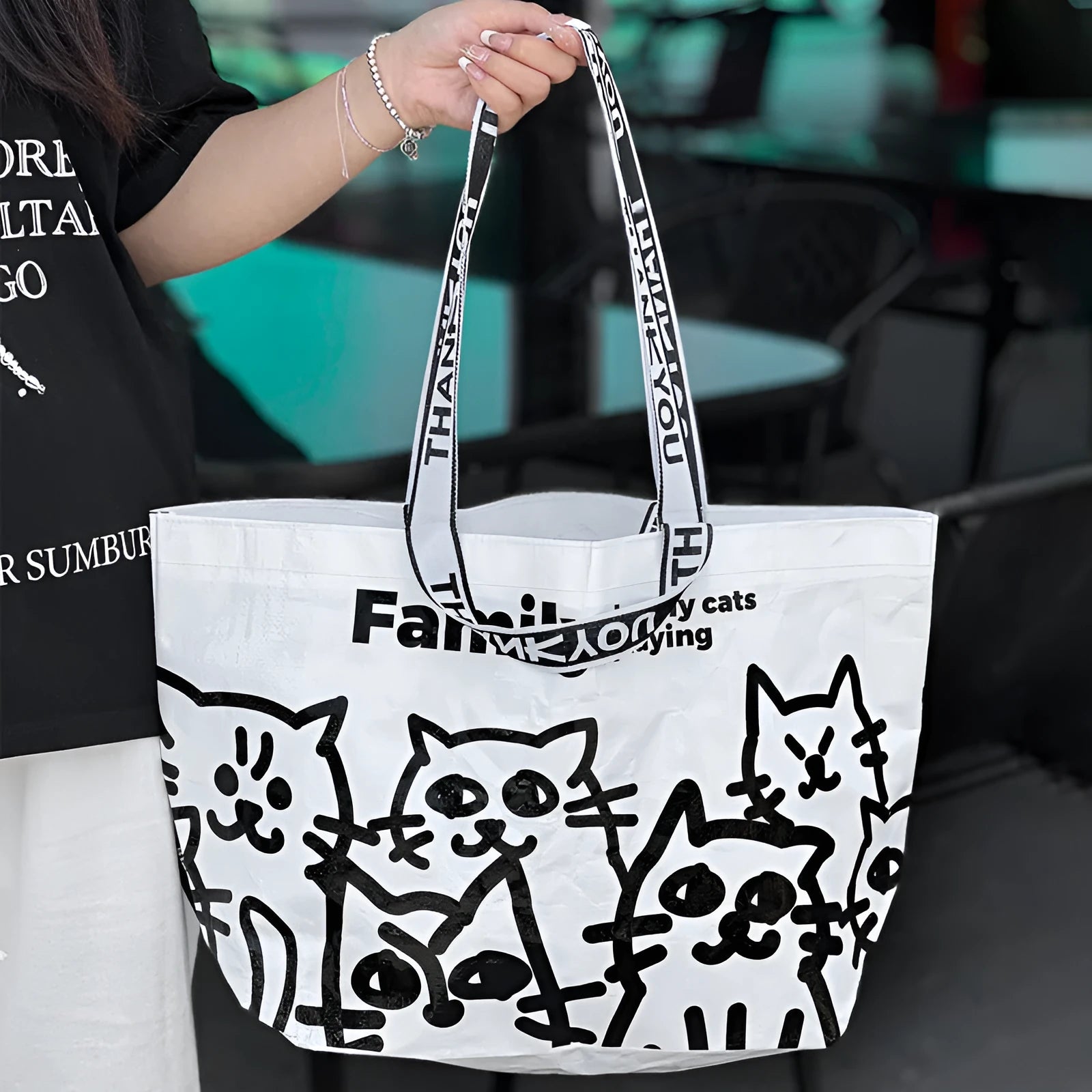 A waterproof woven handbag with a snakeskin pattern colour print, made from PP material.