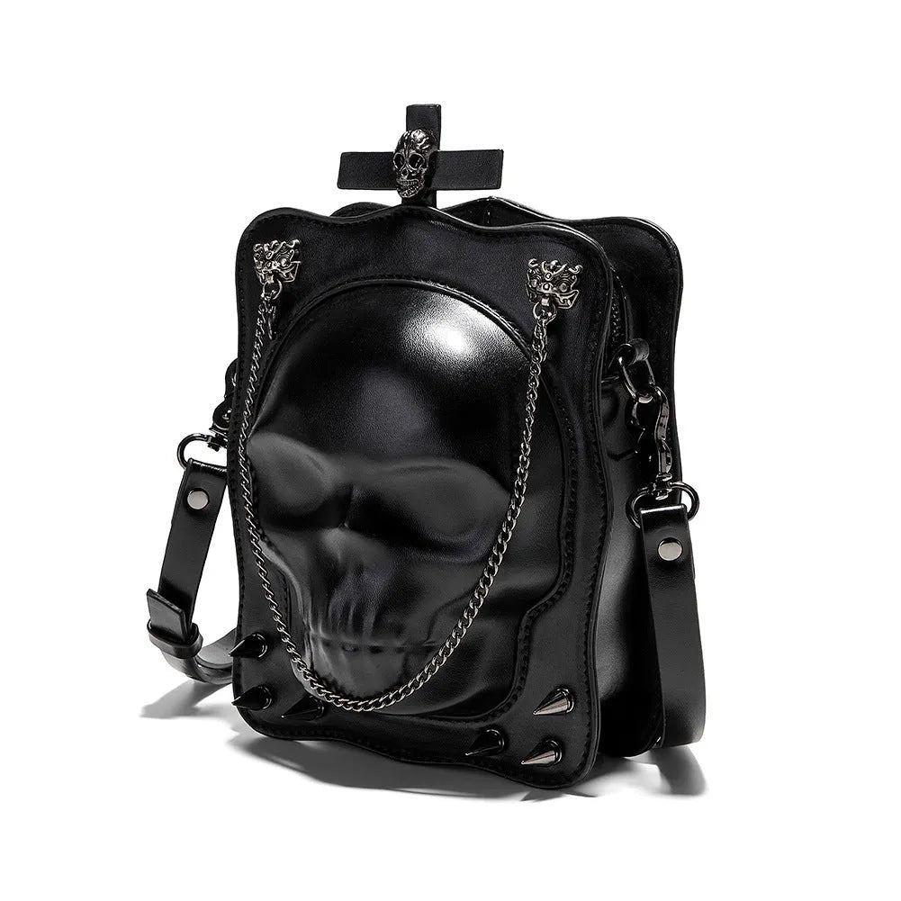 Black vertical square mini crossbody bag with embossed skull design, metal rivets, and chain strap.