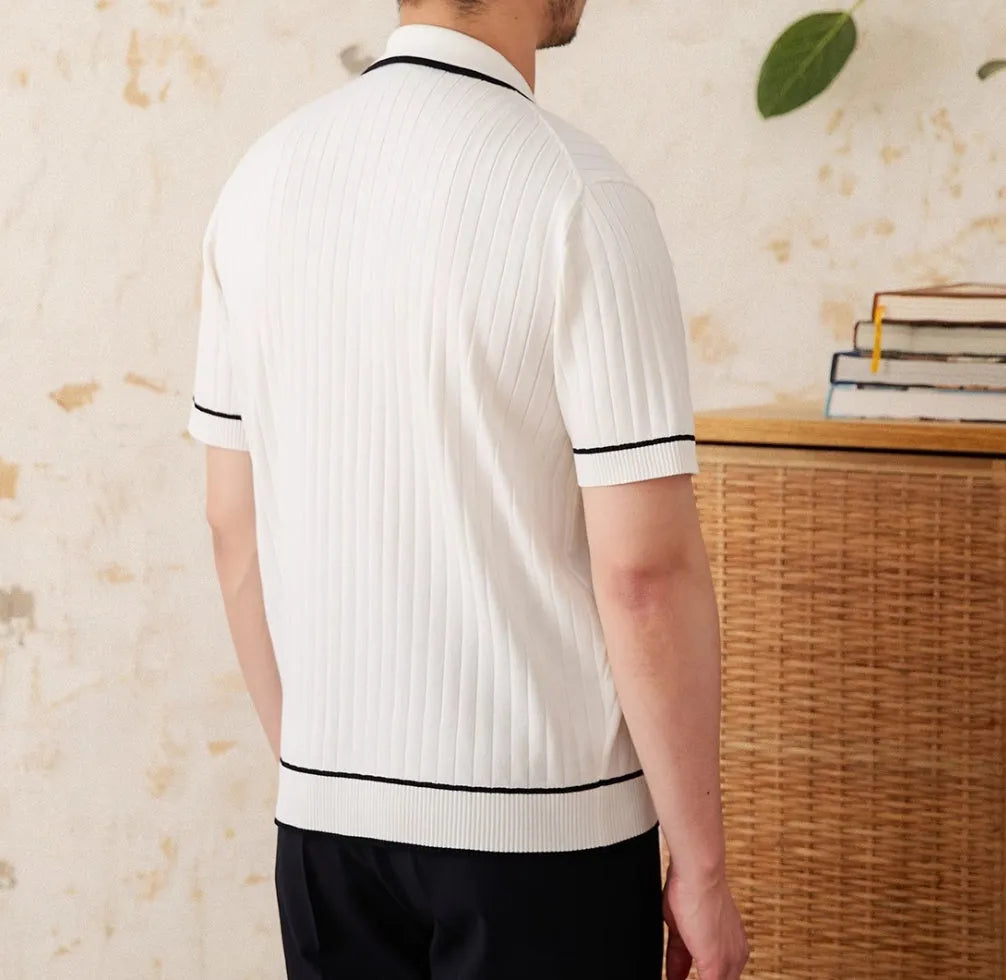 Slim fit black knitting polo shirt with short sleeves and a lapel collar laid flat.