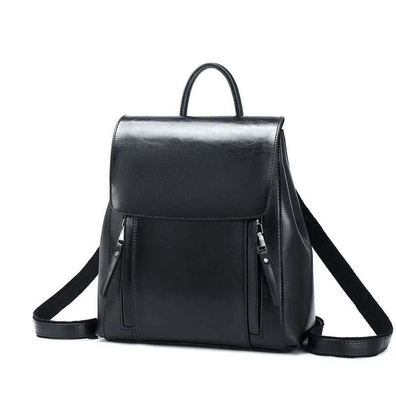 Black genuine cowhide leather women's backpack with double straps and a flap cover, showing internal zipper and phone pockets.