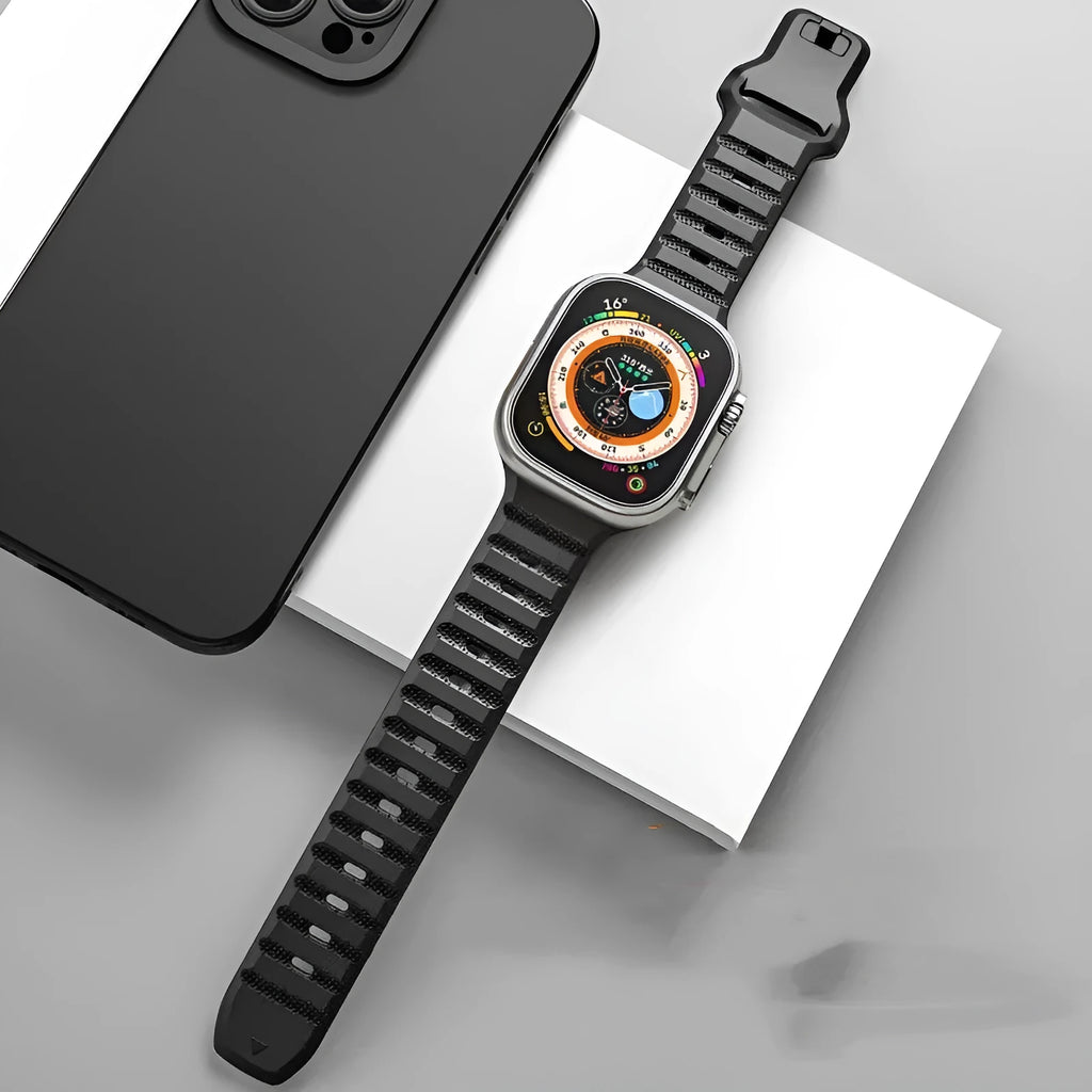 Black fluoro rubber Apple Watch strap with T-buckle on a wrist, showing lightweight design.