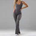 Women's seamless milk silk yoga bodysuit in black with built-in chest pads and full-length trousers.