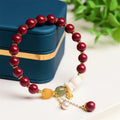 Natural cinnabar bracelet with rabbit design in purple gold sand colour, showing 8mm and 10mm bead size options.