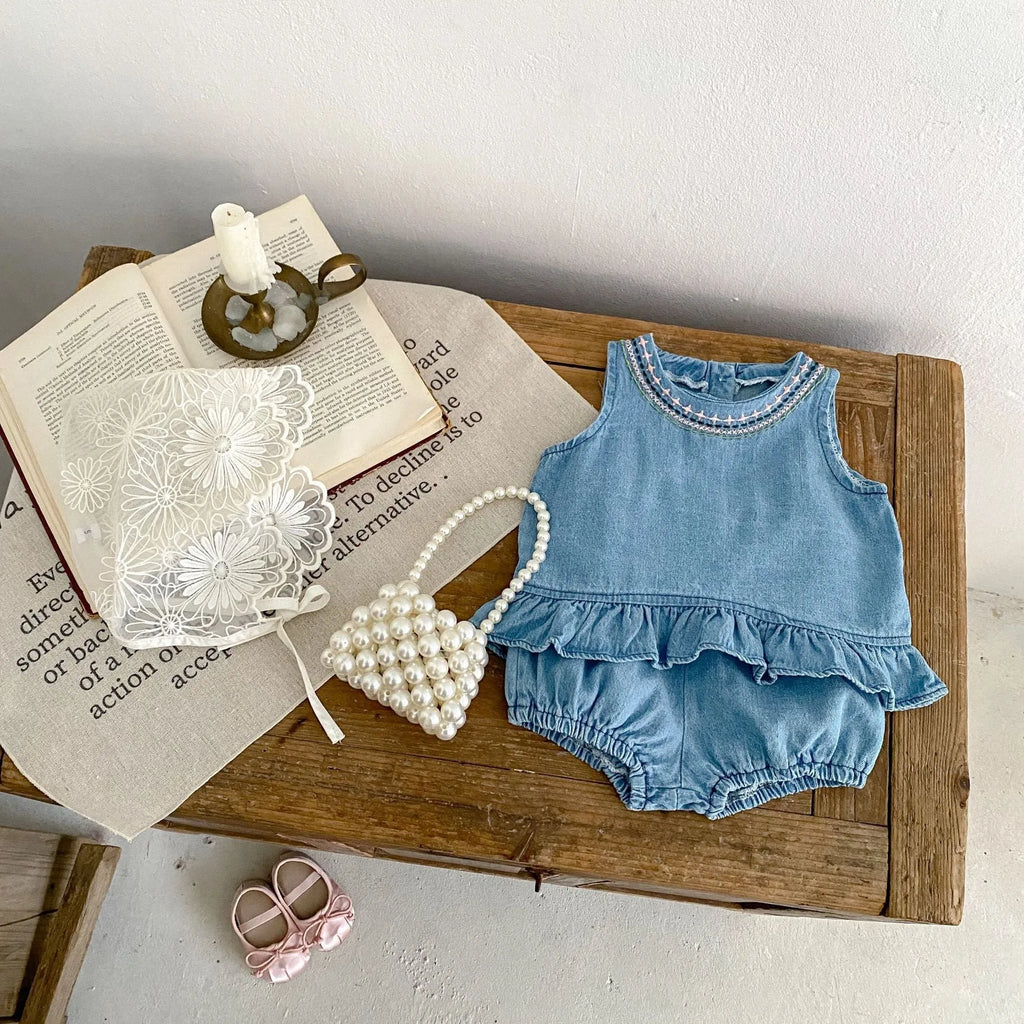 Baby girl denim cotton sleeveless two-piece suit with shorts on a white background
