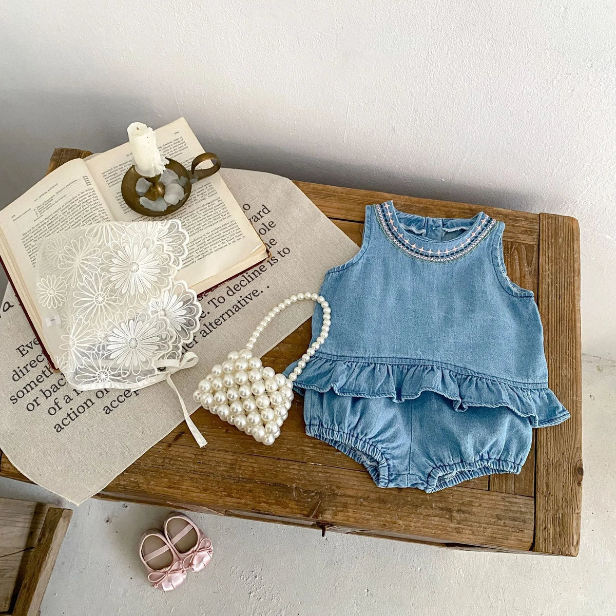 Baby girl denim cotton sleeveless two-piece suit with shorts on a white background