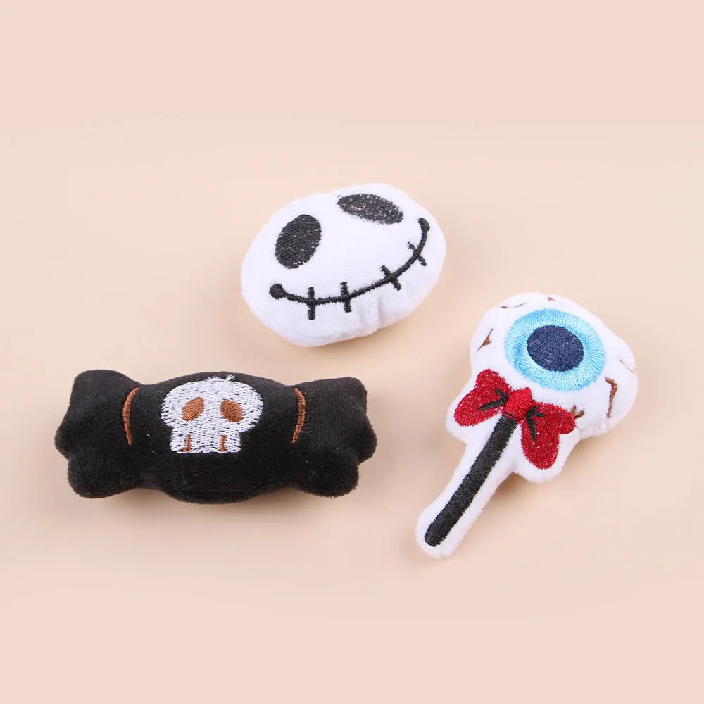 Small plush cat teaser wand with colourful eyes, candy and skull shaped attachments