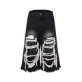 Black wide leg cropped jeans with distressed patch details and a mid-high waist.