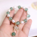 Green freshwater pearl bracelet with geometric strawberry beads and Chinese knot closure