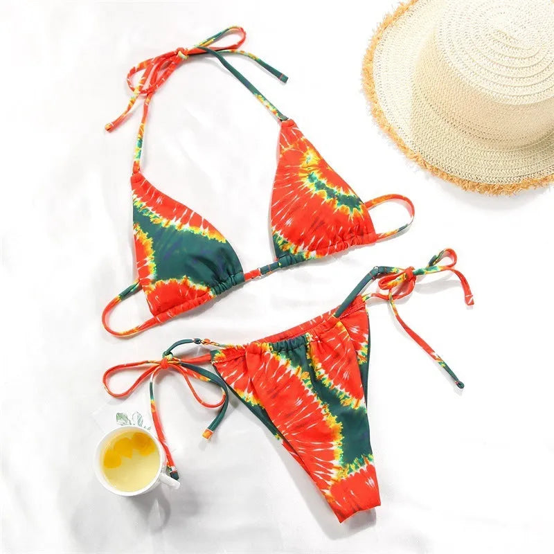 Women's polka dot and floral print split swimsuit bikini set on a mannequin.