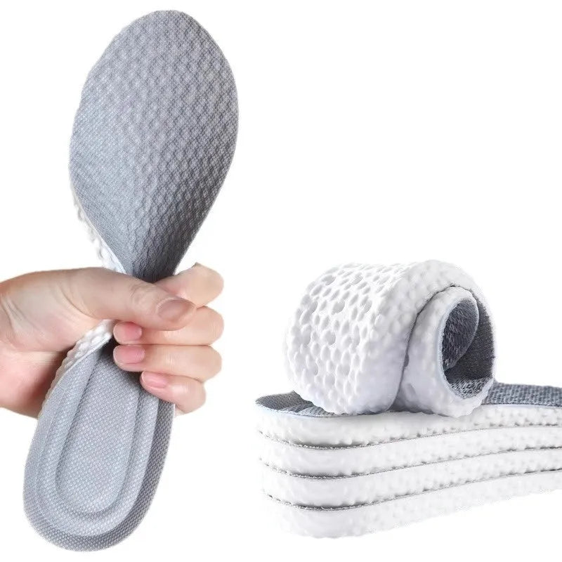 A pair of grey breathable sports insoles made of soft PU material, shown alongside scissors to illustrate the trimmable feature.