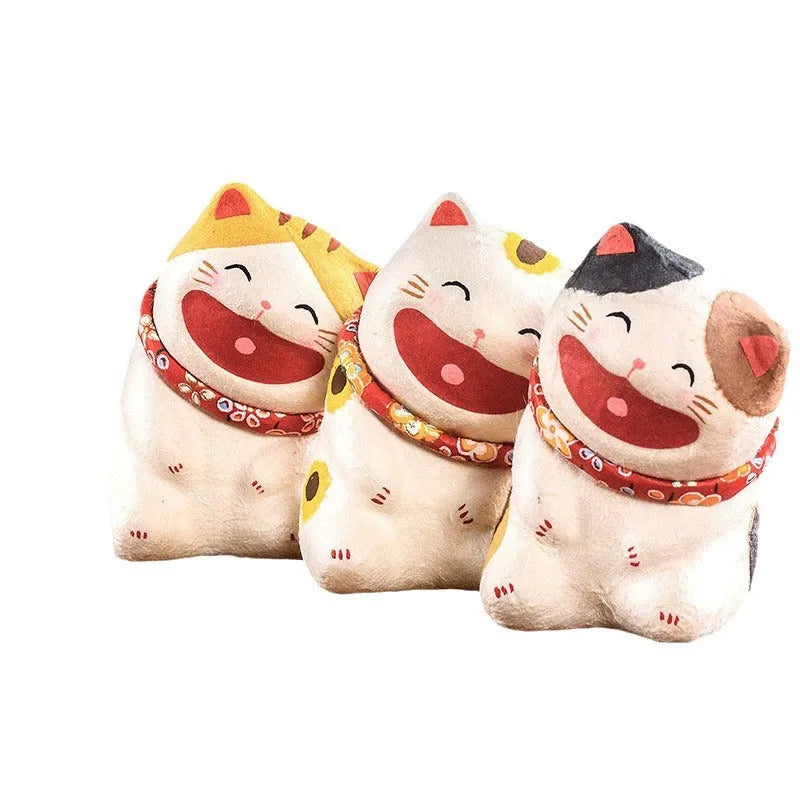 Handmade Japanese paper lucky cat figurine in Sanmao cat style, sitting on a car dashboard